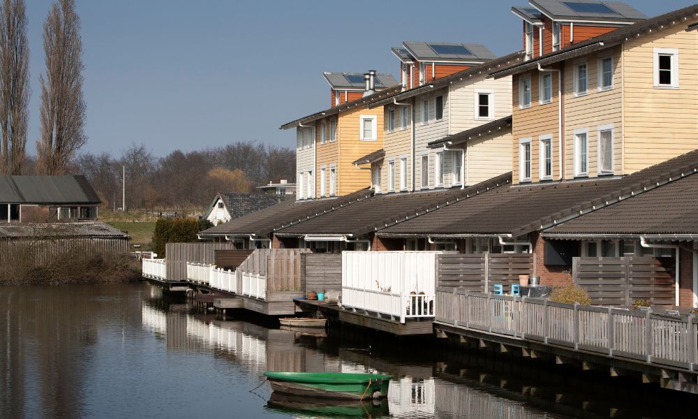 Row of homes in Minneapolis near water showing flood risk areas for flood elevation surveys and insurance.
