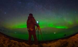 Boundary line survey under aurora lights - ALTA SURVEY Minneapolis Surveyor using GPS equipment for a boundary line survey under the aurora borealis during a solar storm.