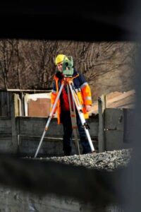 Boundary surveyor at work property line survey - ALTA SURVEY Minneapolis Licensed land surveyor using GPS equipment to measure property lines.