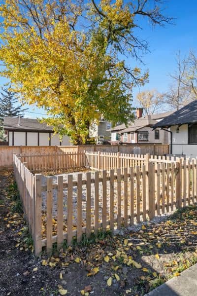 Wooden fence marking a residential property line, showing why accurate boundary line surveys are essential to avoid disputes.

