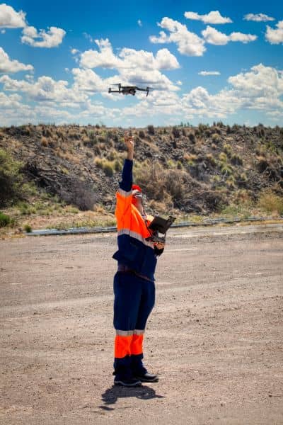 Surveyor performing drone surveying over a residential property to confirm boundary lines.
