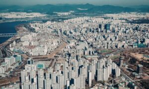 Aerial view of dense urban commercial properties showing why an ALTA Survey is critical for managing risk in high-value real estate transactions