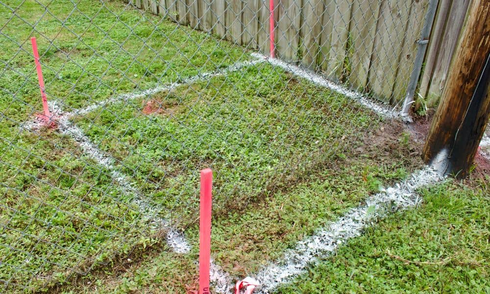 Backyard property boundary markers - ALTA SURVEY Minneapolis Backyard with boundary stakes marking the property line survey area for garage planning