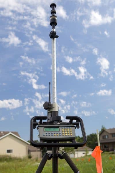 Survey equipment field measurement - ALTA SURVEY Minneapolis Survey equipment used to measure land during a property line survey in a residential area