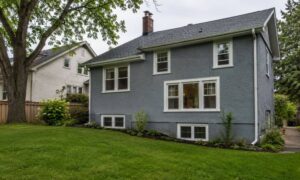 Home with basement windows and a sloped yard, where an elevation certificate may be needed before remodeling