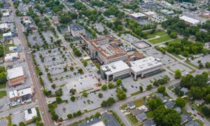 Aerial view of an urban area with parking lots, streets, buildings, and access points relevant to survey mapping