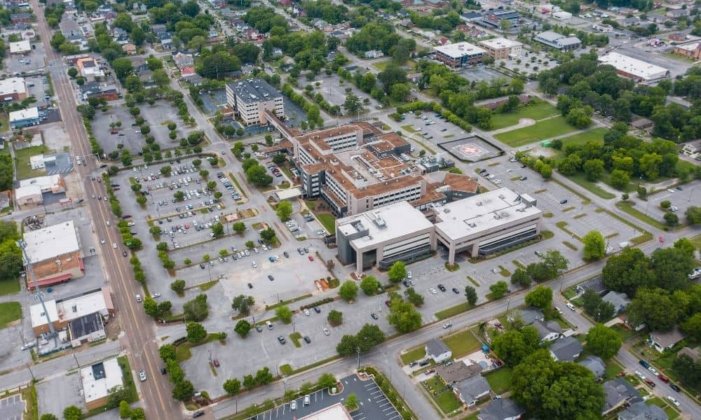 Aerial view of an urban area with parking lots, streets, buildings, and access points relevant to survey mapping
